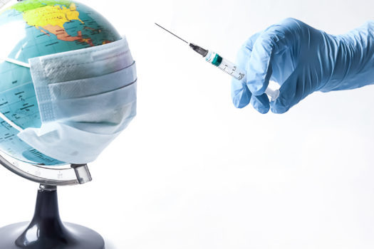 Pandemic concept, close up of scientist injecitng vaccine into the earth.