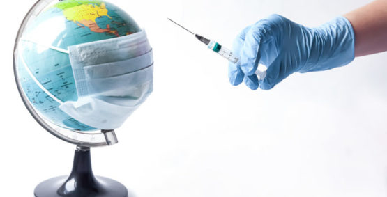 Pandemic concept, close up of scientist injecitng vaccine into the earth.