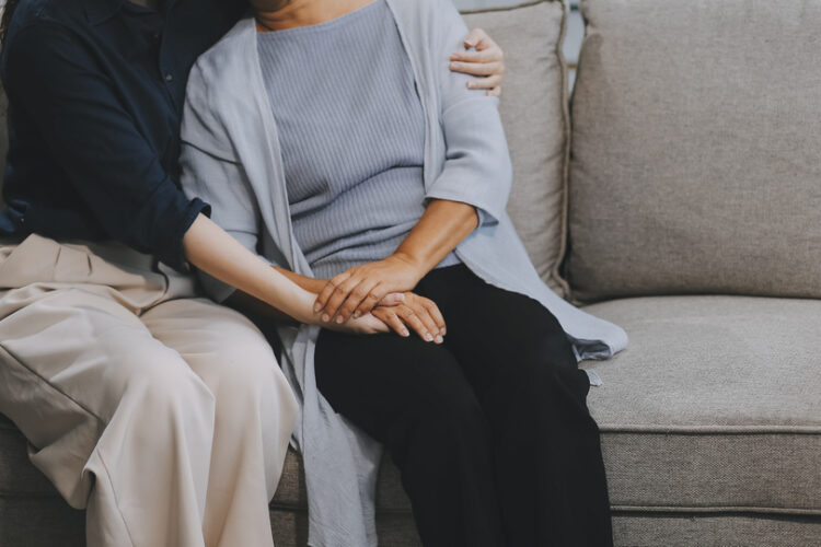 Sad teen granddaughter hugging depressed mature grandmother, giv